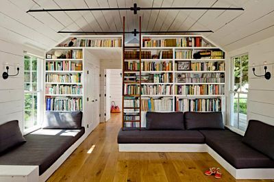 Custom-built attic shelving systems turned into built-in bookshelves by Jessica Helgerson on remodelista.com