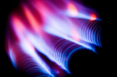 Natural gas furnace coils and flame. Photo by FlutterbyPhoto on iStockphoto.