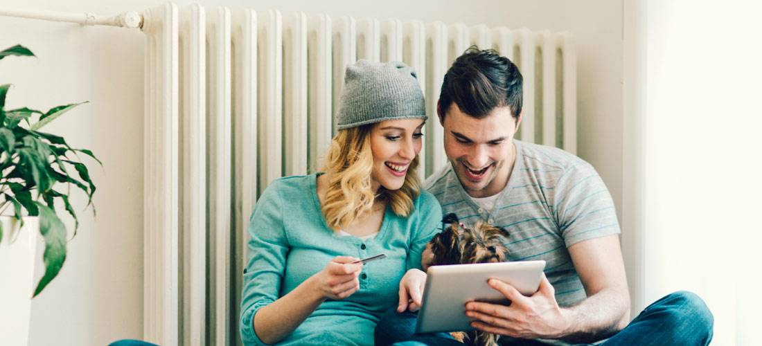 couple-sitting-in-front-of-radiator