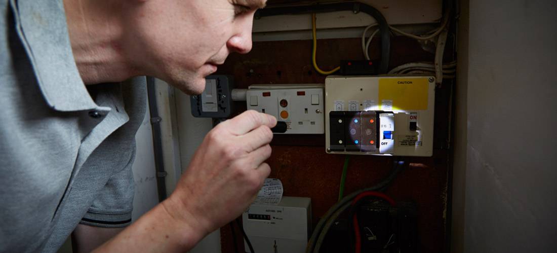 man-checking-fuse-box